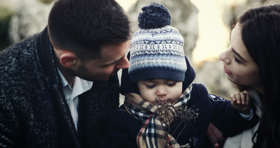 Parents kissing their son. Nature, on the top of mountain. SLOW MOTION