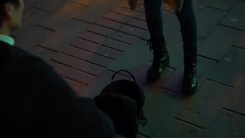 Girl gives money to a street musician. 50 fps.

