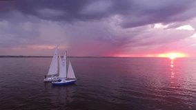 Two yachts at sunset on the high seas in a romantic dream trip, Pink sky. Nice view.