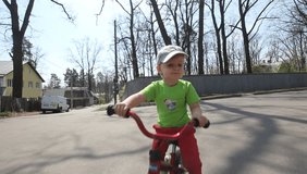 little boy on a bicycle stopped and thought