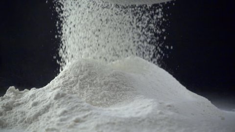 Slow motion shot of sifting flour through sieve