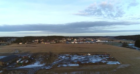 KemiÃ¶ fields, Cinema 4k aerial flight above fields towards downtown KemiÃ¶, at a sunset, on a snowless winter evening, in KemiÃ¶nsaari, varsinais-suomi, Finland.