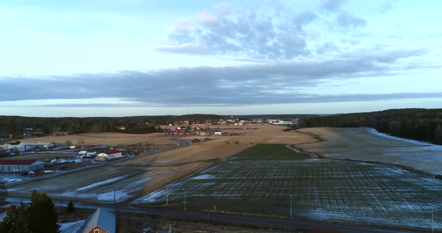 KemiÃ¶ fields, Cinema 4k aerial flight above fields, at a sunset, on a snowless winter evening, in KemiÃ¶nsaari, varsinais-suomi, Finland.