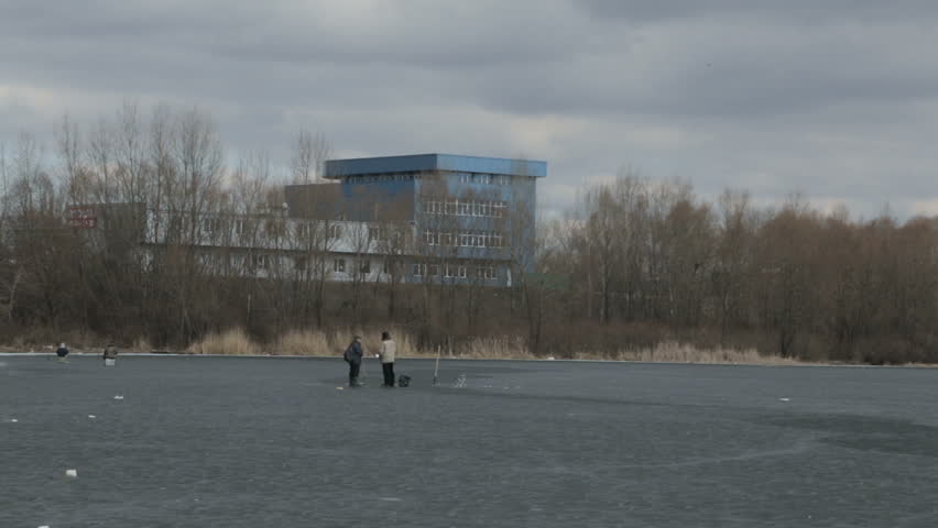 Winter fishing in the middle of a frozen lake.