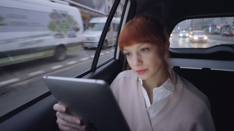 Woman in the Car Having a Tablet Skype Conversation