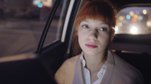 Businesswoman Looking Around While Sitting in the Car