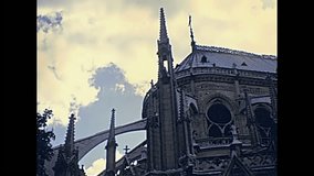 Notre Dame Gothic cathedral in Paris, France with the spires on east side of the church. Historic restored footage on 1970s with no people. Details close up.Popular tourist attraction in Paris.
