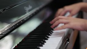 Young teenage hand enjoy playing piano closeup interior blur background