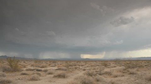 Time Lapse storm clouds and lightening on a desert plain.