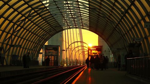 Bucharest, Romania - January 12, 2017: Basarab Overpass, modern station with steel and glass structure at sunset.  Urban scene of a tram entering the station.