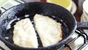 Food Preparation - Chebureki Fried In Oil.Woman preparing chebureki (crimean tatar national dish) at home.Chebureki , fried in oil, popular meal of Caucasian cuisine