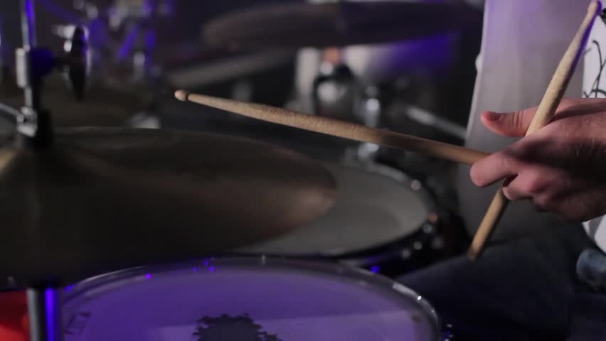 The drummer hits the drum with wooden sticks creating sound. The concert cover band in a nightclub. | Shutterstock HD Video #24776021