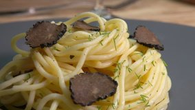 thin slices of black truffle falling on spaghetti