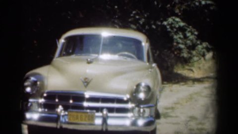 NEW ORLEANS LOUSIANA 1949: beautiful vintage car on dirt road in forest setting.