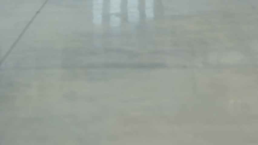 Tilt up of African and Caucasian businessmen talking and walking towards the camera in office building