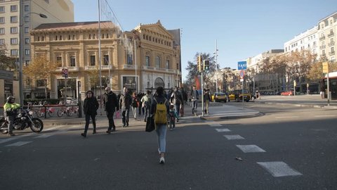Barcelona 4th of January 2017: Anonymous crowd of people walking on zebra crossing rush hour commuters city centre center shopping bags cars popullation