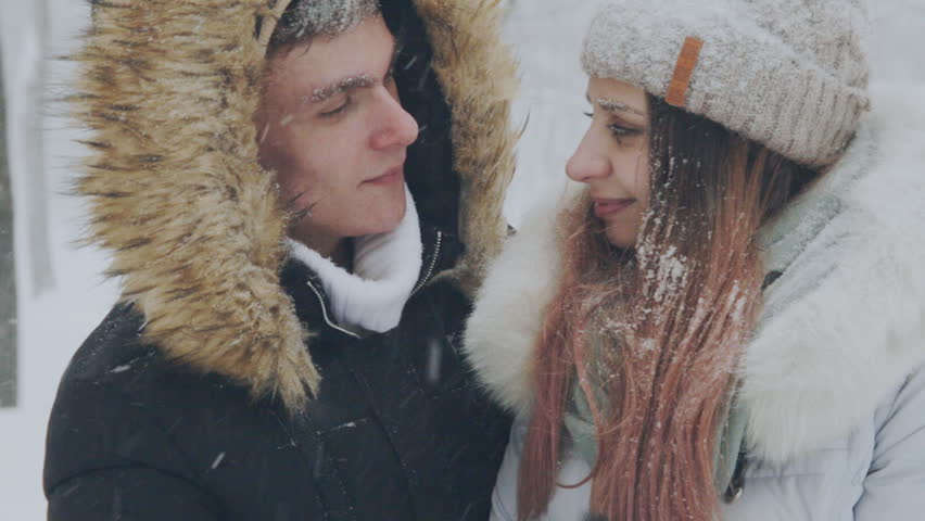 young couple in love in the snow-covered forest