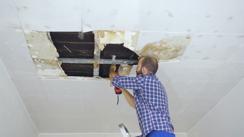 Man Repairing Collapsed Ceiling Panels, How To Fix A Collapsed Ceiling