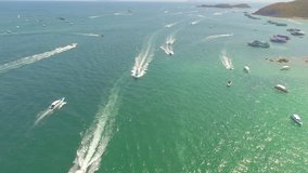 Aerial view of speed boat in sea is going to Island. Speed boat at sea, view from above. Aerial video of speedboat floating in a turquoise blue sea water. Motorboat crossing ocean. Tropical landscape.