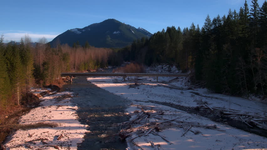 Low aerial tracking shot of a river in Washington state in winter.
Nisqually River in western Washington.  January 2017.