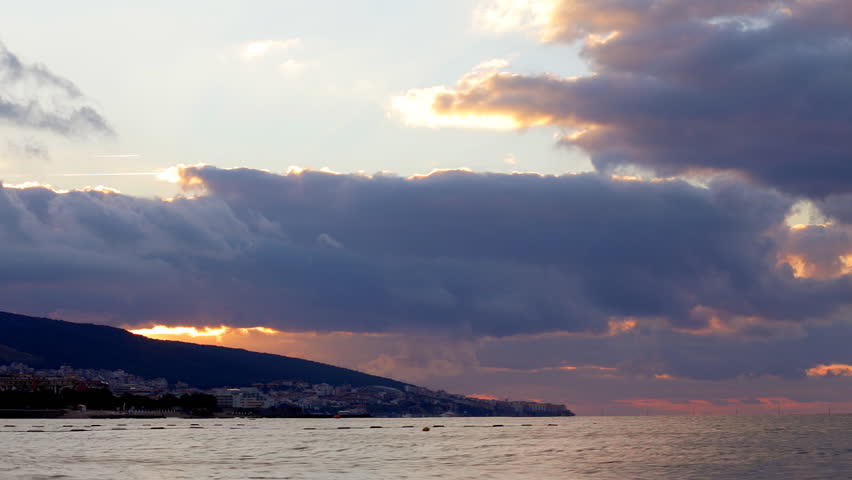 HD scenic sunrise background sun rising. Timelapse of sun rising behing sea and mountains in Nessebar, Bulgaria