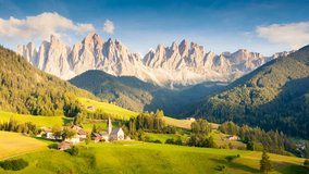 Sunny day in St. Magdalena village. Picturesque and gorgeous scene. Location famous place Funes valley, Odle Group, Dolomiti Alps. Bolzano - South Tyrol, Italy. Europe. Beauty world. Time lapse clip.