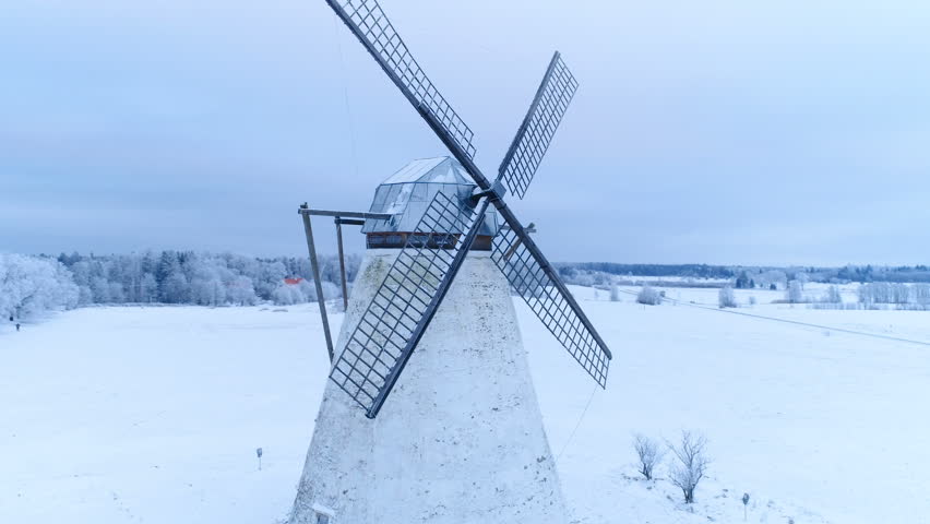 The small old Vihula windmill on a winter season with thick white snow covering the ground in Lahemaa Estonia