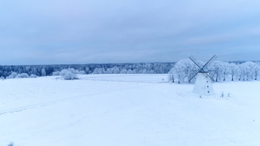 The white Vihula windmill in the middle of Lahemaa with the thick white snow on a frozen winter season in Estonia