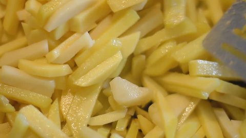 close-up person frying french fries