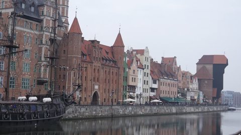 GDANSK, POLAND - MAR 11, 2017: Beautiful embankment buildings architecture and ancient ship
