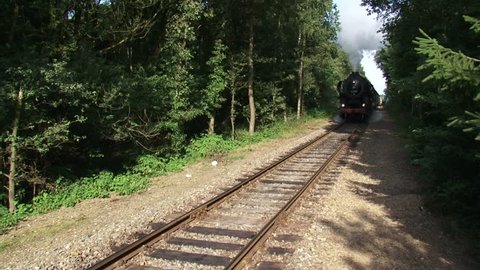 approaching steam hauled passenger train. Steam locomotive 52 8053 (Henschel & Sohn, Kassel) with vintage passenger wagons called Blokkendozen. VELUWE, THE NETHERLANDS 