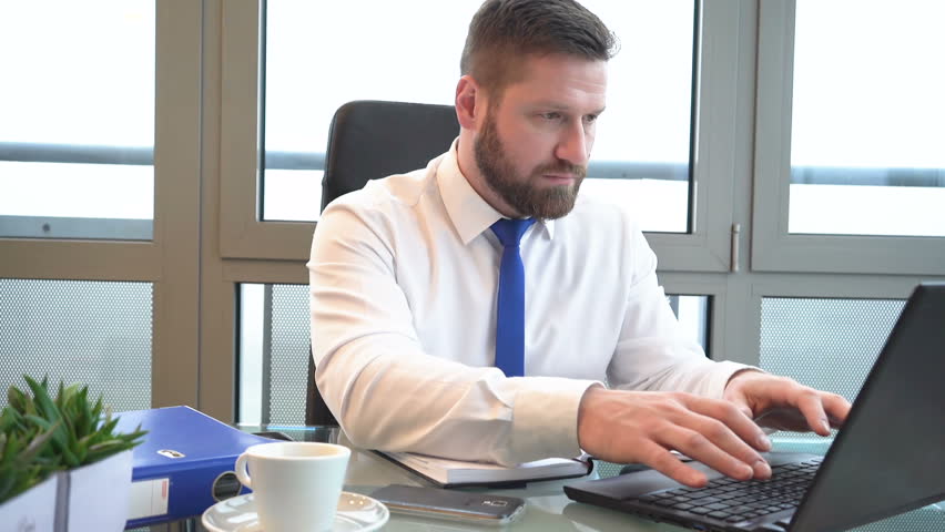 Businessman typing on laptop computer, answers phone call, portrait, slider shot
 Royalty-Free Stock Footage #24843602