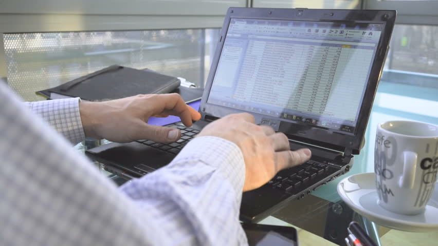Close up of hands analyzing financial data on laptop, in office, behind shot Royalty-Free Stock Footage #24849644