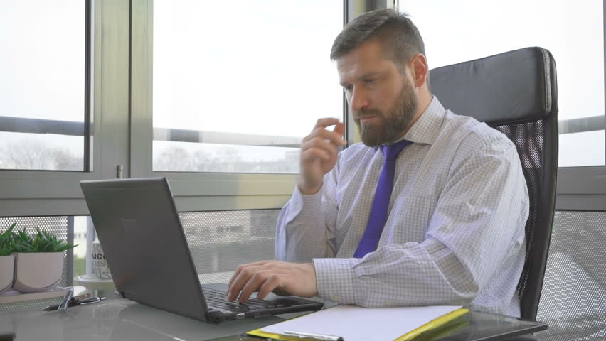 Sad troubled worried, businessman browsing laptop computer, in office Royalty-Free Stock Footage #24849689