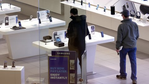Burnaby, BC, Canada - March 07, 2017 : Top shot of customer shopping at Samsung store inside Burnaby shopping mall with 4k resolution