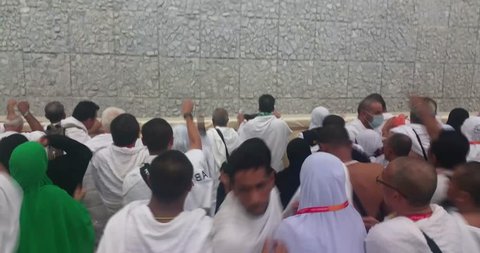 MINA, september 2016, Muslim pilgrims perform 'stoning of the devil' ritual at one of the wall pillars (jamrah)  in Mina, Saudi Arabia. Stoning of devil is one of the rituals to complete the hajj