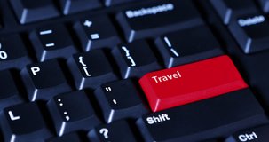 Video footage of human hand pushing a Travel button with red color on the computer keyboard