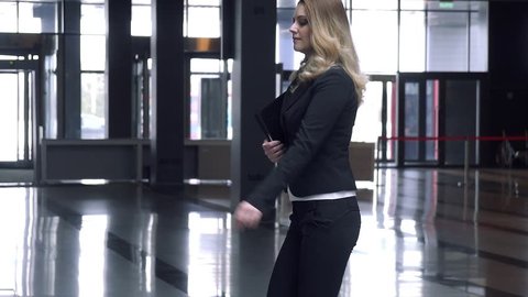 Attractive business woman walking in office building