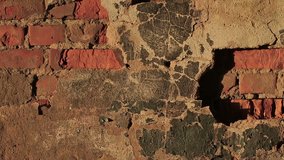 Old wall of red brick and the destruction of plaster. Video full hd.