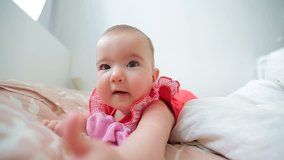 Small happy baby on the bed. Video full hd.