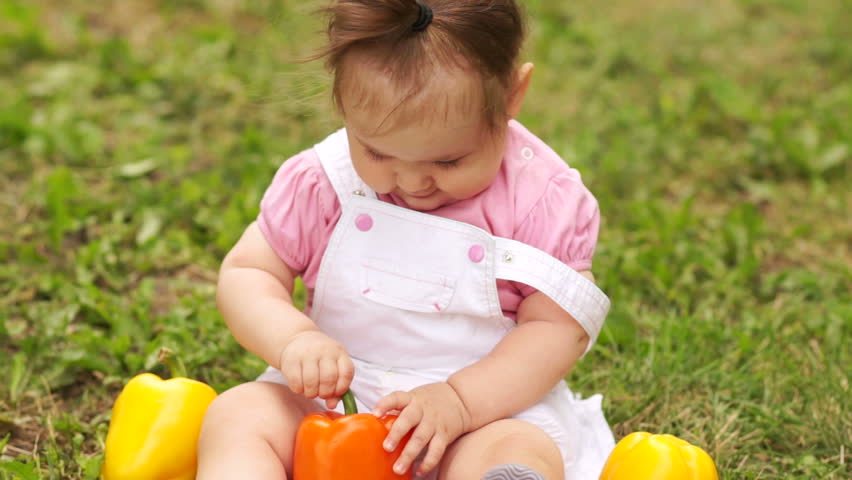 Smiling baby girl with pepper
