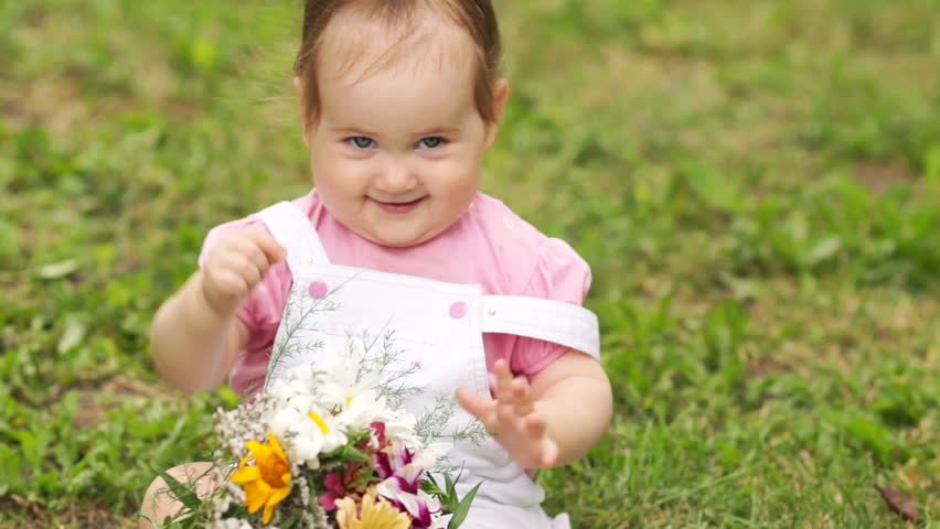 Smiling baby girl with flowers