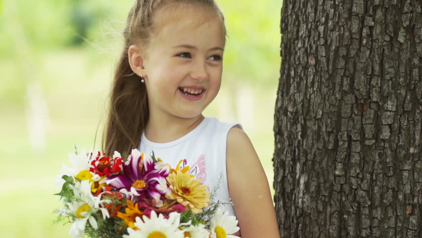 Girl with a bouquet of flowers looking at camera