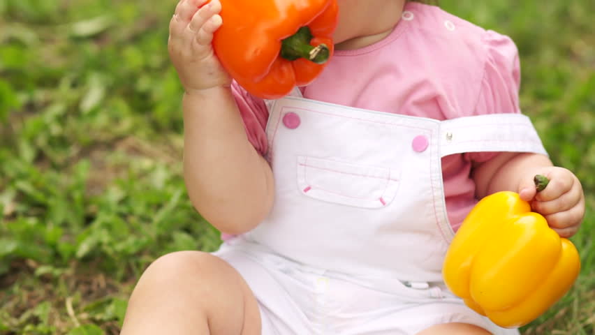 Baby girl with two peppers