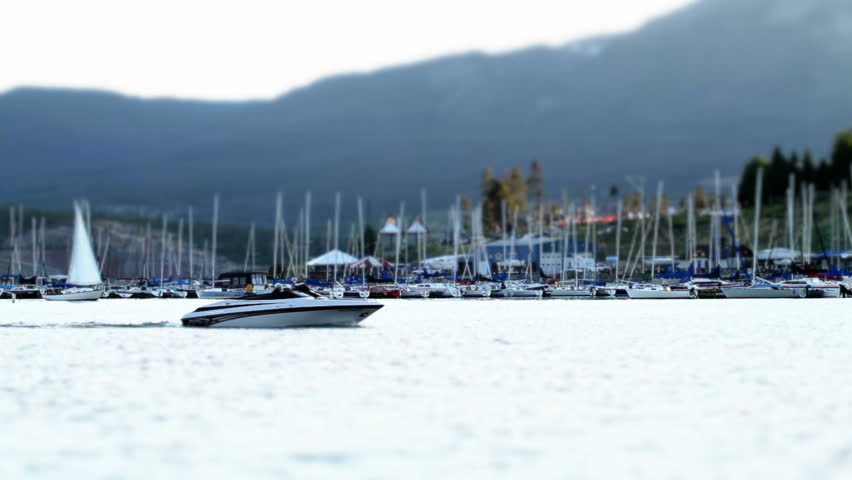 Motorboat in marina on a mountain lake. Tilt-shift effect. HD 1080p.