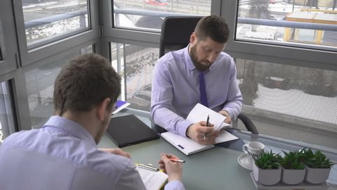 Two businessmen, discussing, analyzing, plan of meeting, in work, office