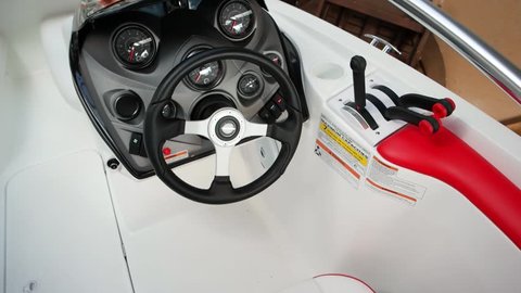 Kherson, Ukraine - 25 August 2016: interior of white and red modern motorboat, details of uptodate boat dashboard and steering wheel, closeup of vessel controls, luxury yacht in Kherson 25 August 2016