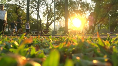 Bangkok, Thailand - FEB 21, 2017 : People are jogging in a public park of Bangkok at sunset, Lumpini Park is one of most popular park in Bangkok.