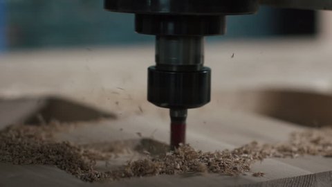Automatic milling cutting wood machine.  drill holes for the pieces of wood. Closeup. Slowmotion