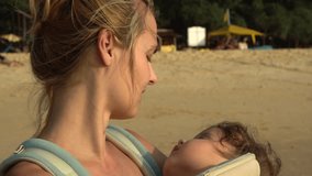 Young Mom Nursing Her Sleeping Baby in Sunset Light. Slow Motion